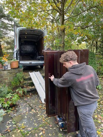 Upright piano being loaded into a removals van