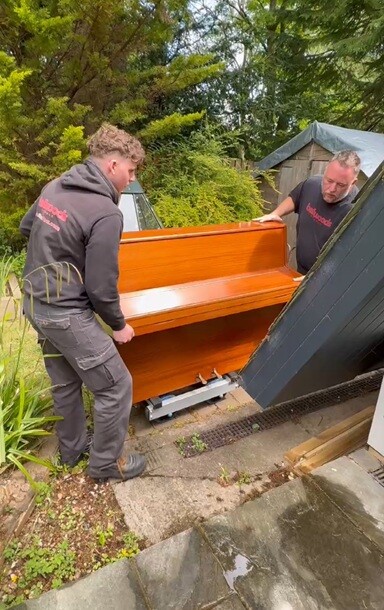 the piano men moving a piano